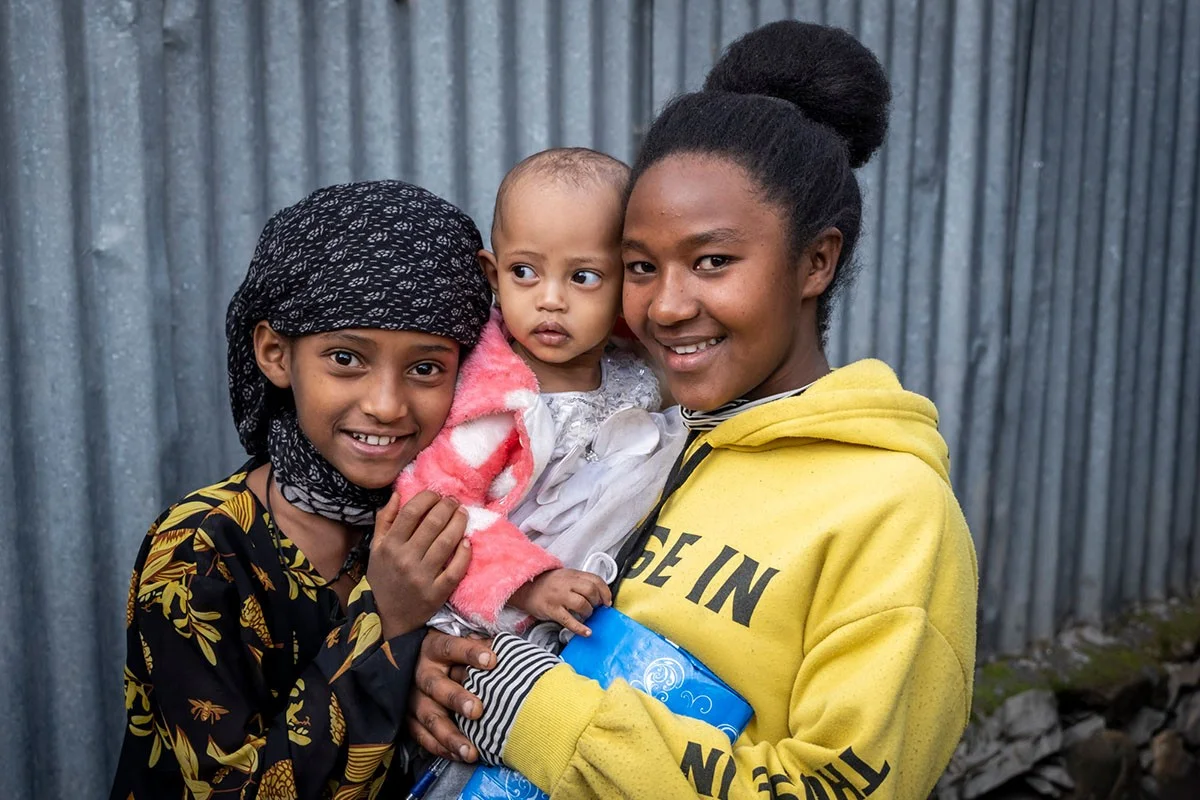 Girl with toddler in her arms