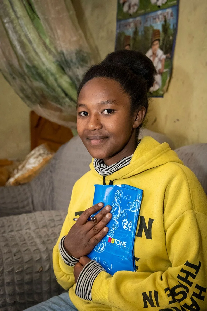 Girl holding diary with hands on her chest