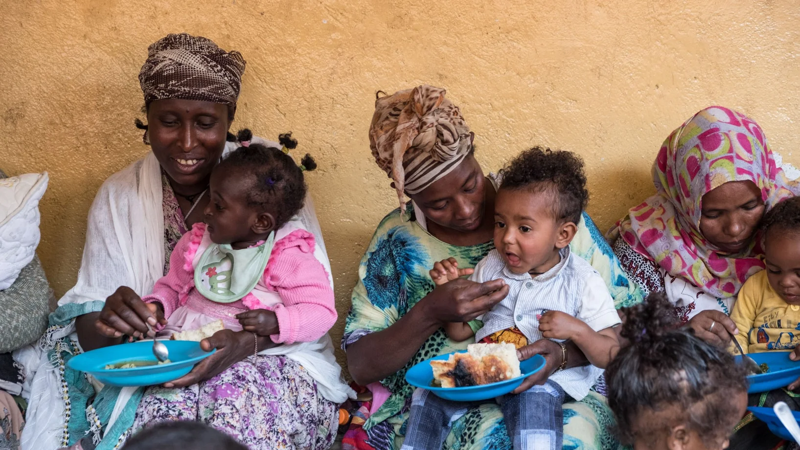 Mütter geben ihren Kindern zu Essen