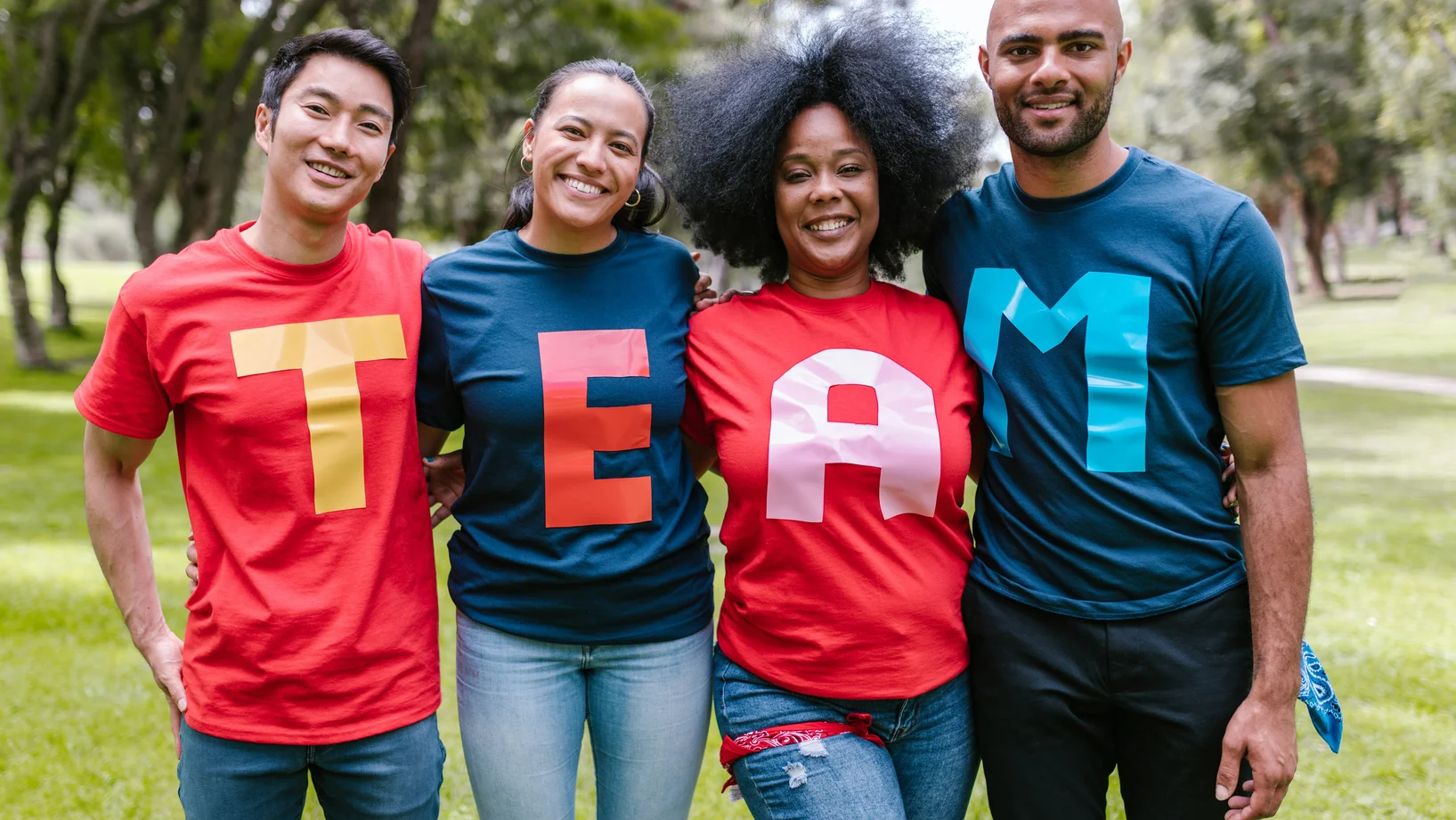 Group of people wearing shirts spelled team